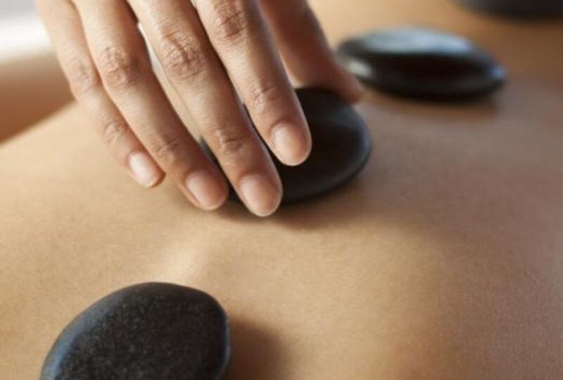 Hot stone full body massage in Llandudno at HUSH Therapies using heated stones