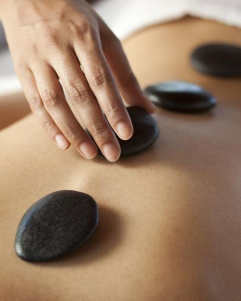 Hot stone full body massage in Llandudno at HUSH Therapies using heated stones