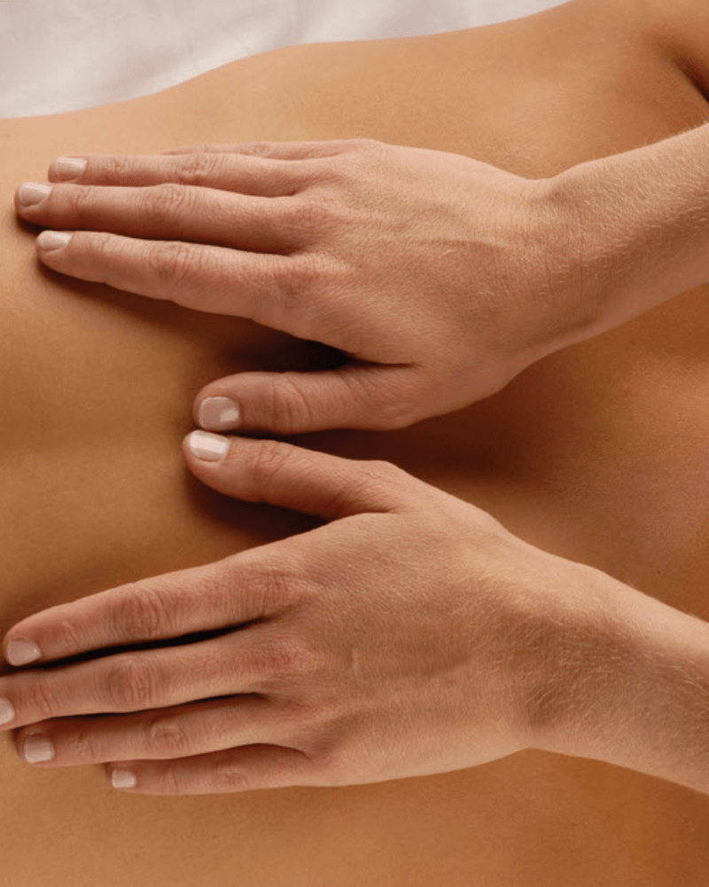 Person enjoying oncology back neck and shoulders massage at HUSH Therapies in Llandudno