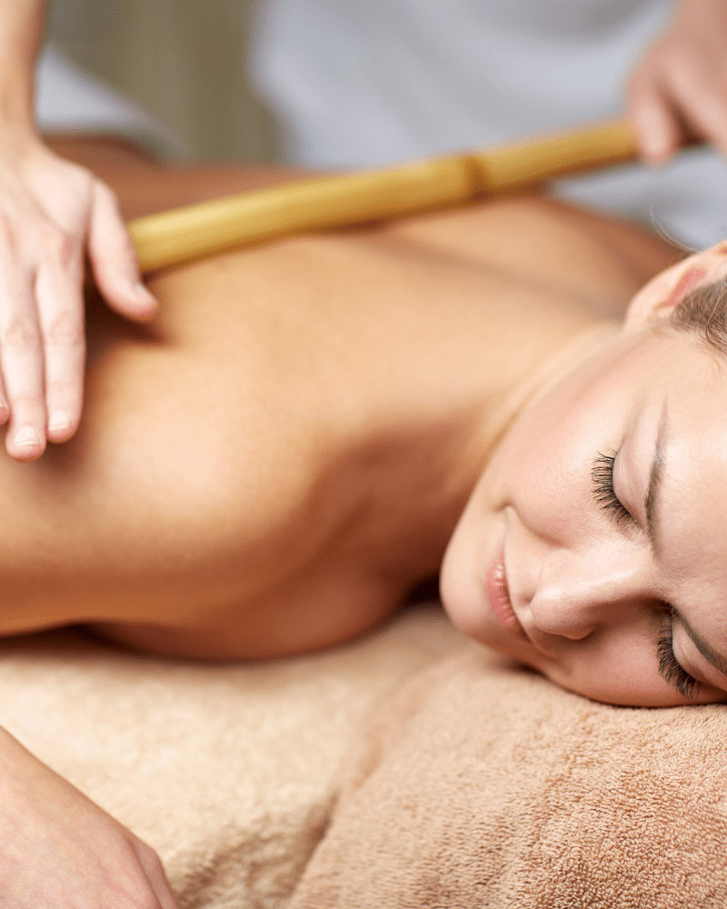 Person enjoying bamboo massage and facial treatment at HUSH Therapies in Llandudno
